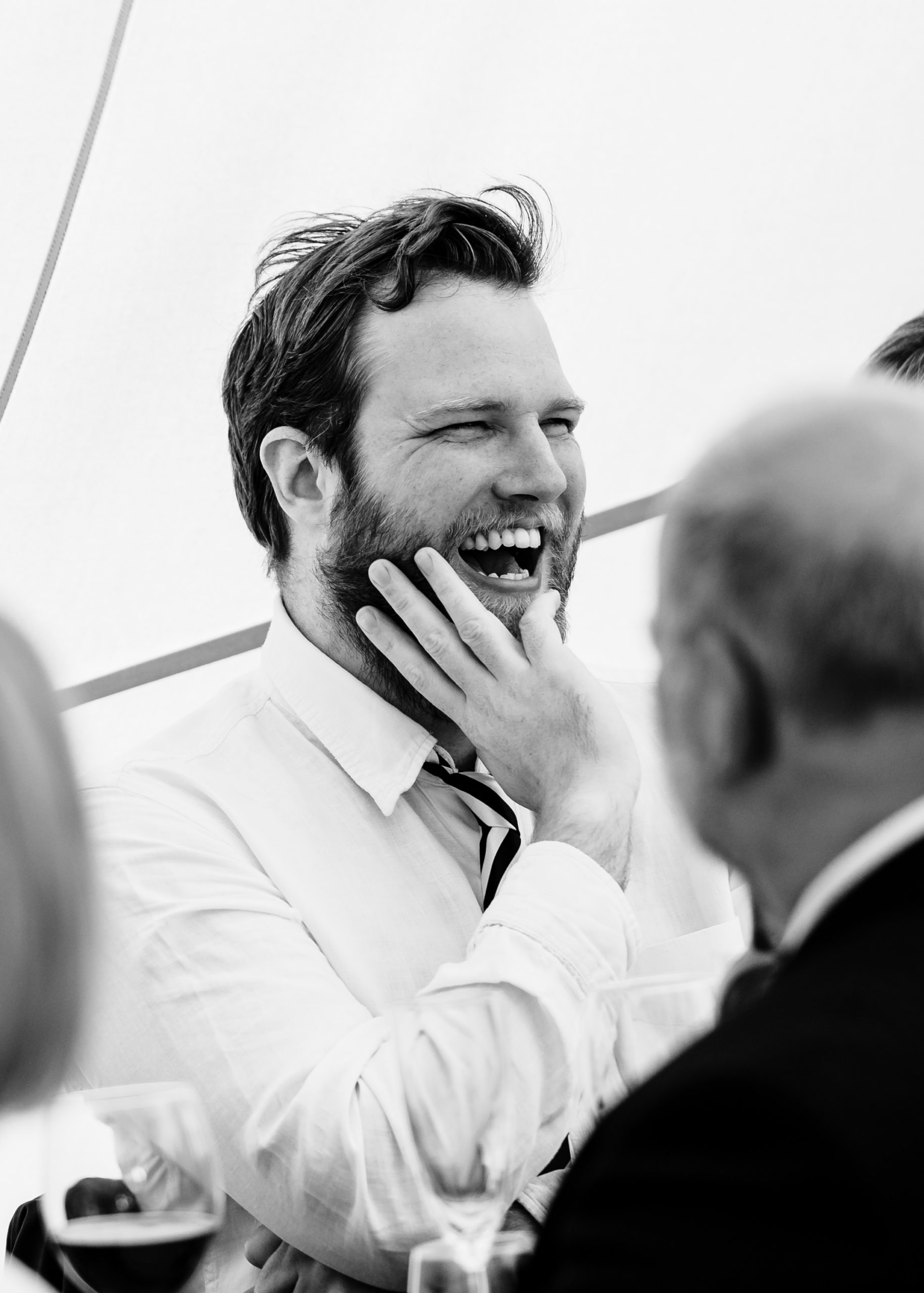 Man laughing during wedding speeches tipi wedding