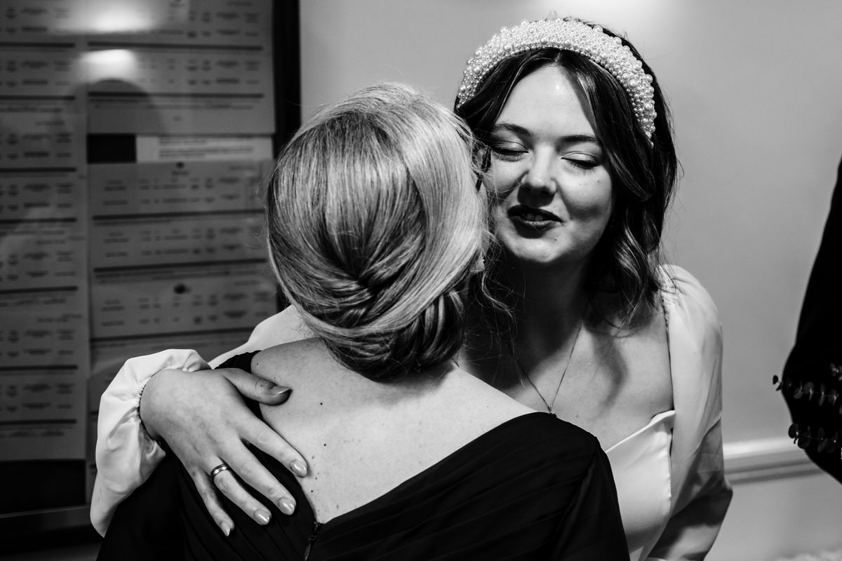 bride giving her mum a kiss before her wedding ceremony at Oakham registry office